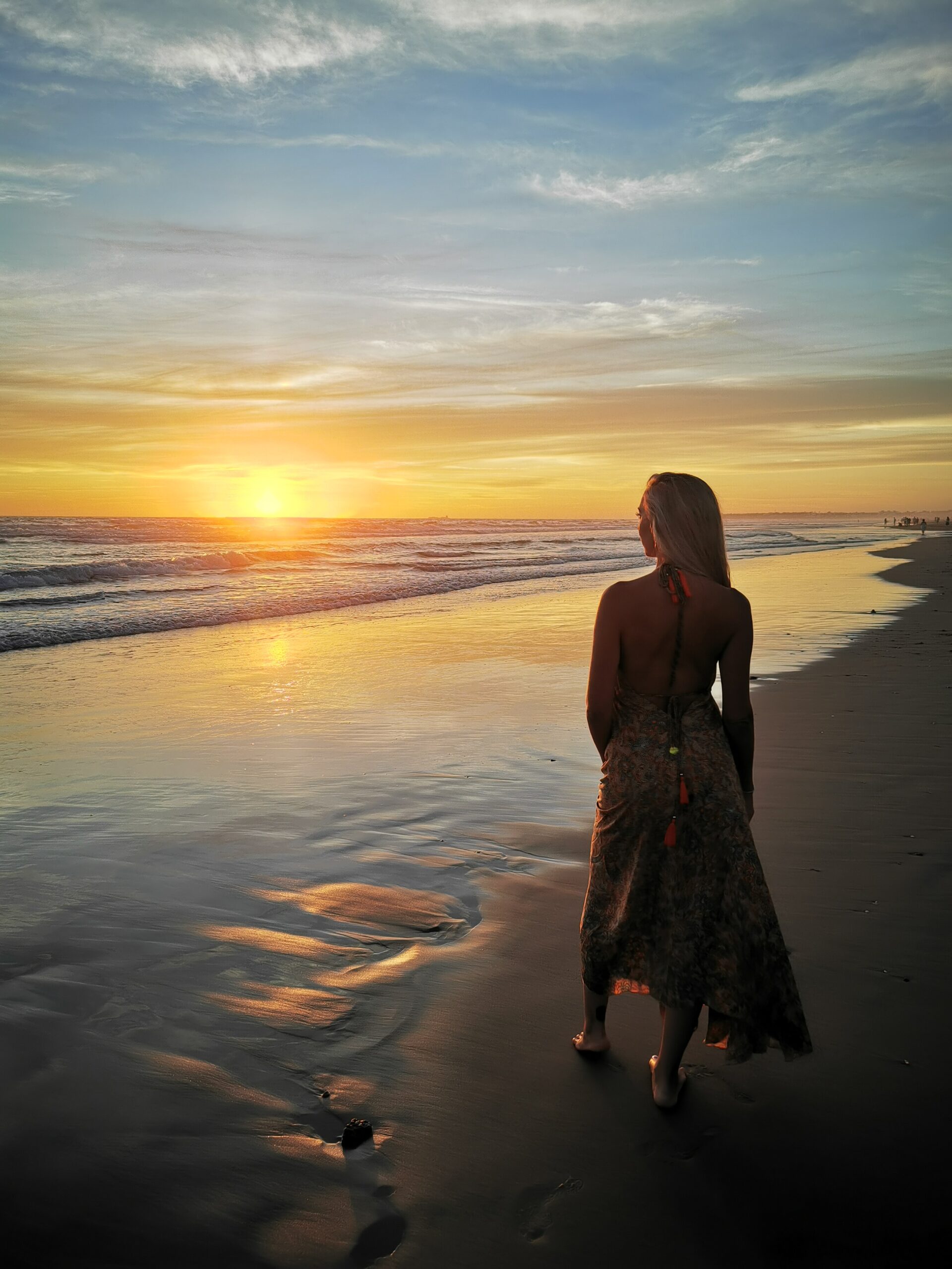rear-view-woman-standing-beach-against-sky-sunset
